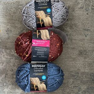 Bernat blanket confetti
Colors: blue,brown and gray flecks. 
3 pkg